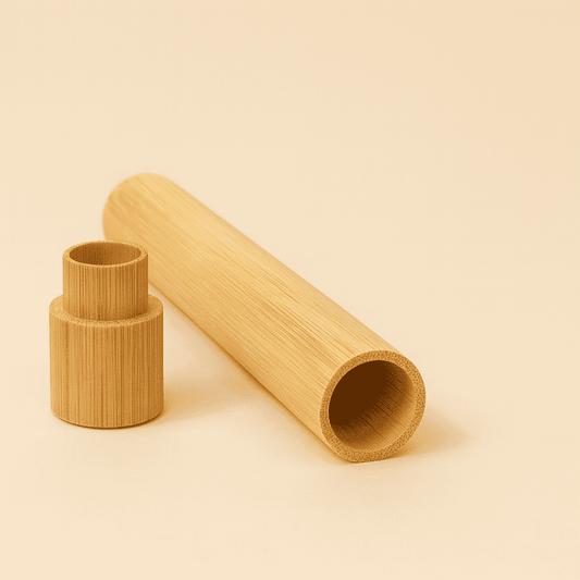 Zweiteiliges, zylindrisches Bambus-Reiseetui (Hülle und Verschluss) auf grauem Untergrund. Natürliche Bambusmaserung für den Transport von Zahnbürsten.